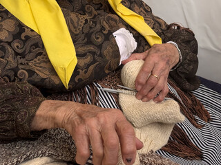very old woman with wool 