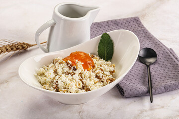 Curd with granola and orange jam