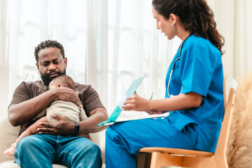 Doctor Examining Baby in Father's Arms.