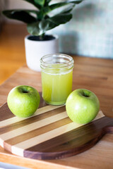 Fresh Green Apples and Homemade Green Juice in a Mason Jar on a