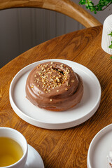 Cinnabon with chocolate cream on a plate