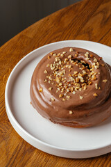 Cinnabon with chocolate cream and nut crumbs