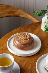 Cinnabon with chocolate cream and nut crumbs