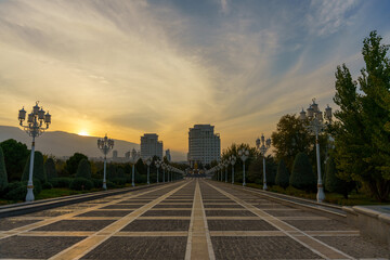 A long, empty walkway with a sunset in the background
