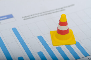 Caution Ahead: Miniature Construction Cone on Financial Chart Signals Business Risks
