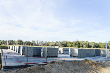 Home construction site with cinderblocks on a concrete foundatio