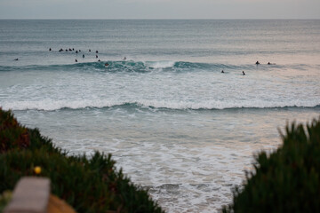 Group of surfers waiting for waves in Baleal, Portugal