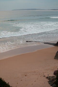 Empty sandy beach with soft waves in Baleal, Portugal