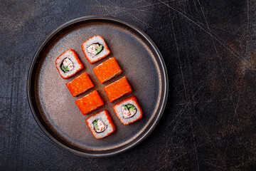 Overhead shot of traditional japaneese roll with crab, cucumber and masago, with space for text © mariashumova