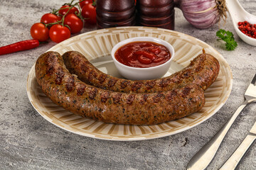 Grilled beef sausages with sauce