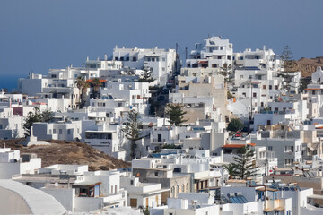 Whitewashed church and houses overlooking sparkling aegean sea in santorini, greece