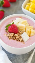 Inviting smoothie bowl topped with granola and assorted tropical fruits for a healthy and delicious breakfast