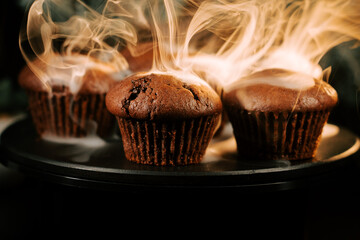 Freshly baked chocolate muffins release steam in a cozy kitchen setting during the morning