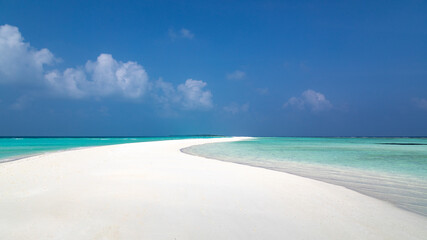 Tropical white sand beach with turquoise water, on an atoll in the Maldives, Indian Ocean