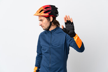 Young cyclist man isolated on white background making stop gesture and disappointed