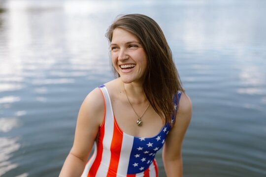 Smiling woman in patriotic swimsuit by Sylvan Lake, SD.