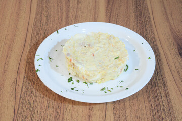 A plate of food with a piece of meat and a side of vegetables