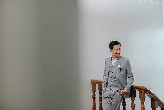 young man leaning on a staircase