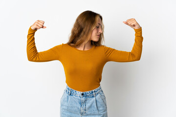 Young blonde woman isolated on blue background doing strong gesture