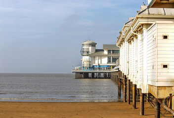 Pier on the beach, early morning, calm sea, clouds, clear sky
