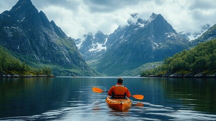A lone kayaker explores a serene, mountainous fjord surrounded by lush greenery under a cloudy sky.