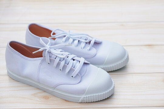 Pair of new trendy white canvas sneakers. Comfortable, fashionable style. Concept, shoes for doing sport or exercise also can wear for traveling, hiking or doing active activity.