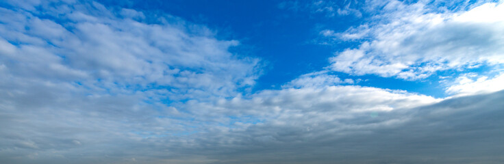 Blue sky with clouds and a few white clouds