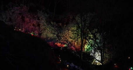 A landscape of colorfully illuminated icicles at night
