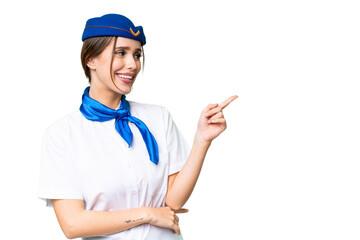 Airplane stewardess over isolated chroma key background pointing finger to the side and presenting a product