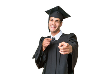Young university graduate caucasian man over isolated background pointing to the front and smiling