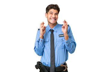 Young police man over isolated background with fingers crossing