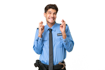 Young police man over isolated background with fingers crossing