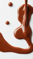 Obraz premium Creamy chocolate sauce drizzle over white background, indulgent, smooth