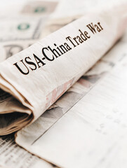 USA-China Economic War and Import-Export Crisis, Rolled newspaper with USA China trade war headline