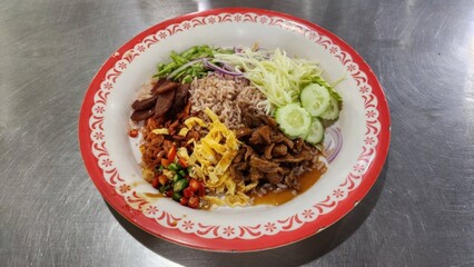 Colorful and Tasty Asian Rice Dish with Fresh Vegetables and Meats