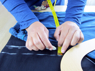 She works as a fashion designer (tailor).