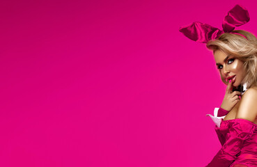 Sexy blonde woman in a bunny costume poses sensually for Easter. Sexy Bunny.