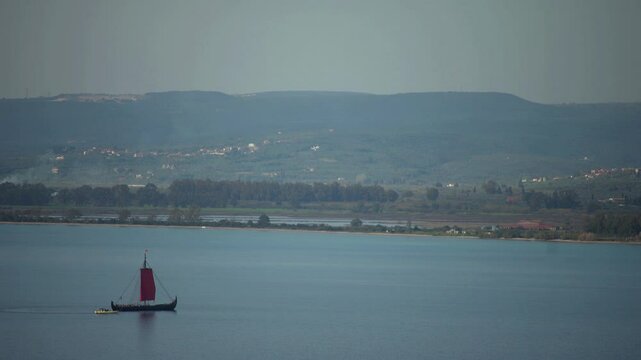Greek trireme ancient rowed warship at calm blue sea
