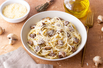 Spaghetti pasta in creamy sauce with mushrooms and cheese. Vegetarian food. Italian cuisine.