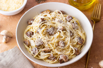 Spaghetti pasta in creamy sauce with mushrooms and cheese. Vegetarian food. Italian cuisine.
