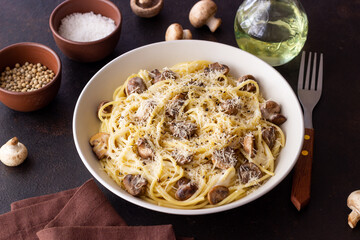 Spaghetti pasta in creamy sauce with mushrooms and cheese. Vegetarian food. Italian cuisine.
