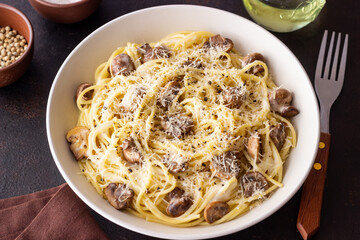 Spaghetti pasta in creamy sauce with mushrooms and cheese. Vegetarian food. Italian cuisine.