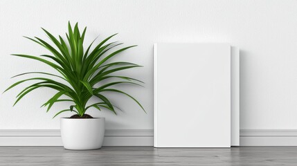 A modern interior scene featuring green plant in white pot next to blank book on wooden floor. minimalist design creates calm and inviting atmosphere