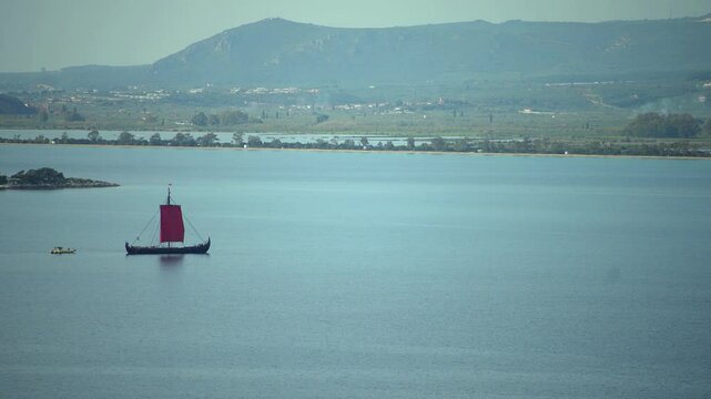 Greek trireme ancient rowed warship at calm blue sea