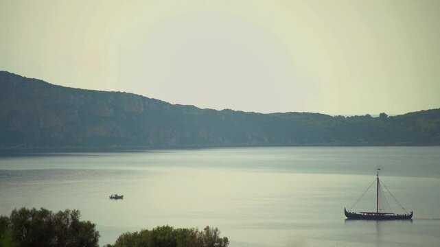 Greek trireme ancient rowed warship at calm blue sea