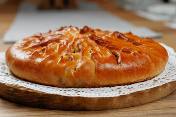 A delicious, freshly baked round bread loaf, perfectly golden, soft, and fluffy, making it ideal for sharing