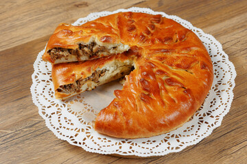 A mouth-watering, golden-brown pastry with a slice revealing its rich filling, perfect for culinary delights.