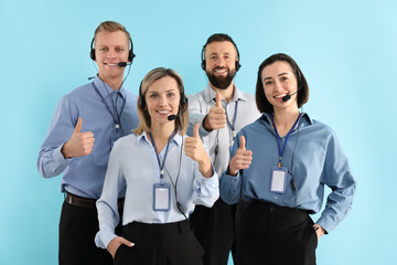 Technical support call center. Team of friendly operators showing thumbs up on light blue background