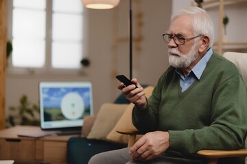 An older gentleman is sitting comfortably in a chair, holding a remote control and watching a screen displaying a nature scene. The room is bright and inviting.