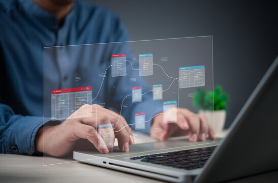 programmer working on database web developer management with a futuristic digital interface, representing data analytics and IT technology. - Powered by Adobe